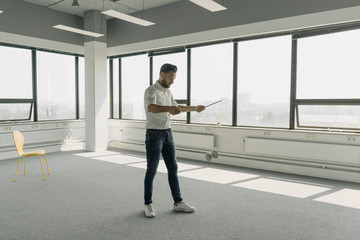 Mature businessman playing with diabolo in empty office