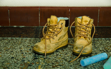 a pair of smalle tiny shoes for children, at the floor