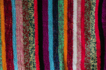 Obraz premium Colorful stripy woolen fabric texture close up. knitted background. Close up texture . wrinkled and shadows, top view