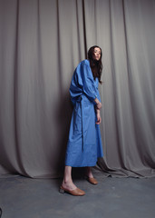 Fashionable photo. Girl model in fashionable clothes, studio shooting.