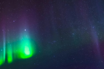 Obraz premium Aurora borealis in night northern sky. Ionization of air particles in the upper atmosphere.