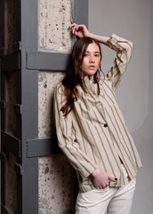Fototapeta premium Fashion photo. Girl model in a suit, studio shot.