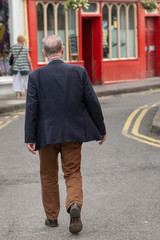 Senior man walking down the street, Kinsale, County Cork, Ireland
