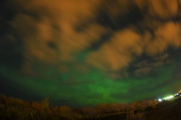 Fototapeta premium Aurora borealis in night northern sky. Ionization of air particles in the upper atmosphere.
