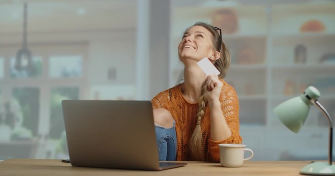 super happy young woman holding a plasic bank card and buying online. happy shopper. Slow motion 4k