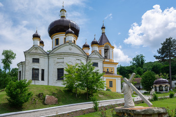 Fototapeta na wymiar Orthodox Monastery Condrita in Moldova. Sculpture of Jesus Christ carrying the cross on the foreground