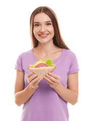 Young woman with tasty sandwich on white background