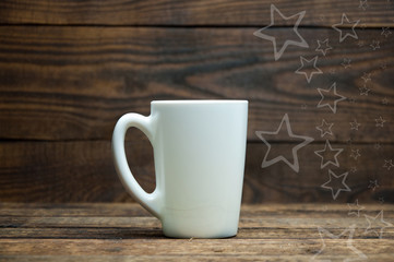 A white cup stands on a wooden table. Tea and coffee in the morning