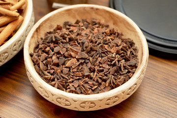 Anise stars in ceramic bowl, close-up. Dry anise stars