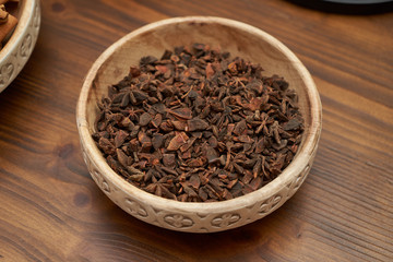 Anise stars in ceramic bowl, close-up. Dry anise stars