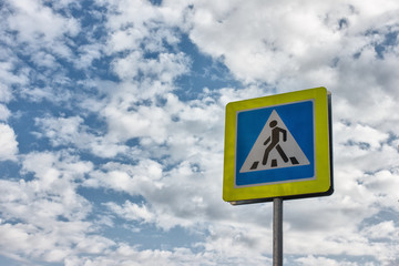 New crosswalk road sign on blue sky background. Concept of road safety, road accident