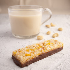 Healthy breakfast. Organic milk. Cereal granola bar. Glass cup with organic milk. Nut milk without lactose, gmo, antibiotics and casein. Diet food.  ..