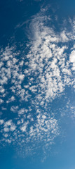 Fantastic clouds against blue sky, panorama
