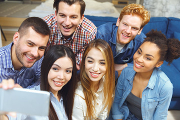 Group of friends having party indoors fun together taking selfie pictures close-up