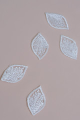 Texture lace fabric. lace on white background studio. thin fabric made of yarn or thread. a background image of ivory-colored lace flowers. White lace on beige background.