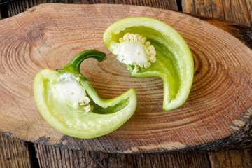 sliced bell peppers on wooden background