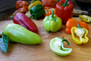 sliced bell peppers on wooden background