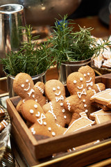 Christmas festive table with dessert cookies in shape of gingerbread man
