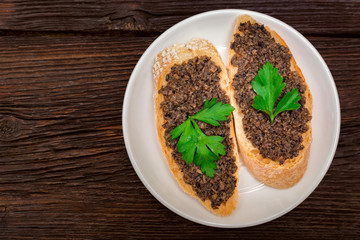 Fresh tasty bruschetta with truffle sauce and parsley. Top view