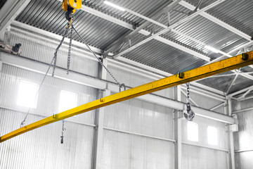 Yellow Factory overhead crane carries cargo at the plant. Cargo moving.