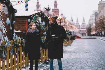 Young couple holding hands and walking on Red Square