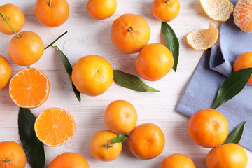 Fresh ripe tangerines on white wooden table, flat lay