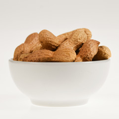 Peanuts in a bowl isolated on white