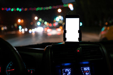 the mockup design of the smartphone attached to the windscreen inside the car