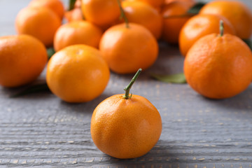 Fresh ripe tangerines on grey wooden table