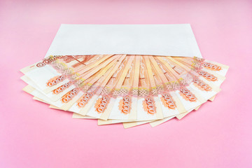 envelope with Russian money on a pink background