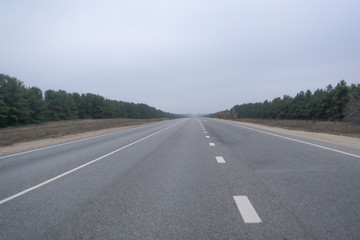 Fototapeta premium the abstract highway road in countryside in the fog rainy weather. danger driving, accident car crash