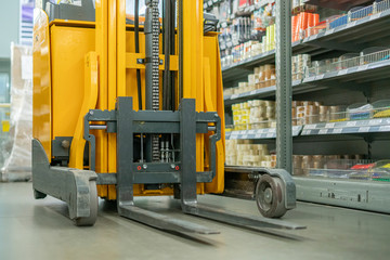 forklift in the warehouse working and lifting the boxes  of new income products