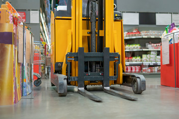 forklift in the warehouse working and lifting the boxes  of new income products