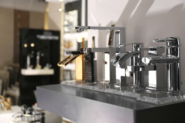 New shiny faucets in bathroom fixtures store. Total wholesale