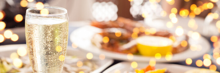 Italian cuisine. Glass of prosecco and variety of seafood. Shallow DOF, banner with gentle festive...