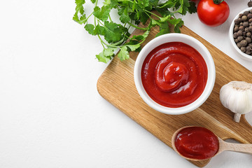 Flat lay composition with tomato sauce on white table, space for text