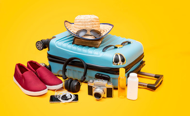 Fototapeta premium Blue suitcase luggage and travelingl banner with causal shoe, holidays concept