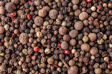 Pepper grains mix as background, top view