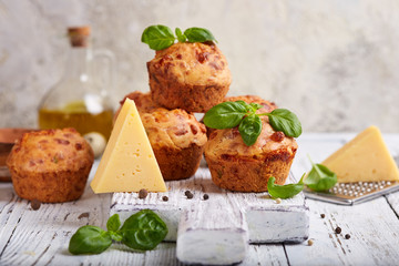 Savory muffins with cheese and basil leaves. Delicious homemade appetizer. 