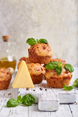 Savory muffins with cheese and basil leaves. Delicious homemade appetizer. 