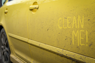 Write the words inscription text " clean me " on the very dirty surface of the car. Concept car wash.