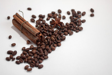 coffee beans. roasted coffee. cinnamon and anise on a light background.