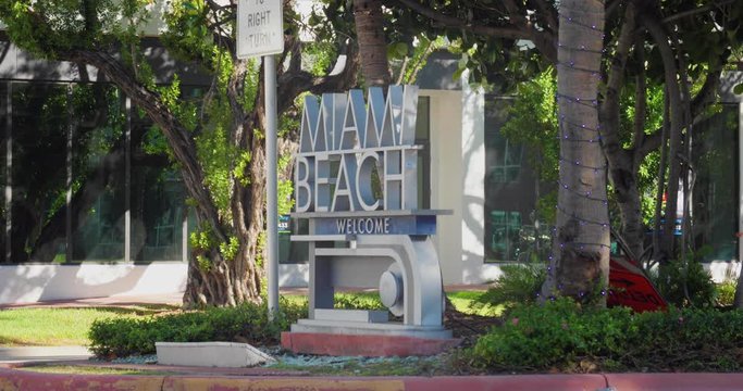An establishing shot view of the famous Welcome to Miami Beach sign on 5th Street.  	