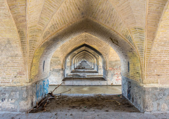 Fototapeta na wymiar Isfahan, Iran - 2 February 2019: Si-o-seh pol Bridge. Also known as Allahverdi Khan and Allahverdi Khan or 33 arched bridge over the Zayandeh river.