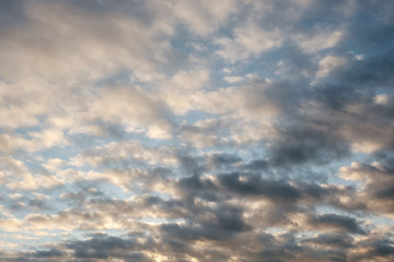The dramatic evening sky in cirrus clouds at sunset