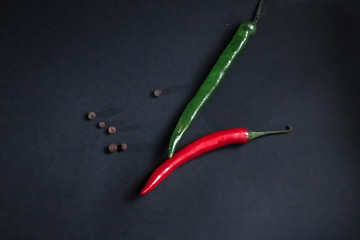 red and green chili peppers on a dark background.