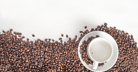 Close up photo of coffee beans and cup top view with copy space