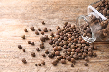 Scattered peppercorns on wooden table, closeup view