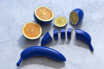 fruits (banana, lemon, orange) in classic blue color. Classic Blue color of the Year 2020 inscription