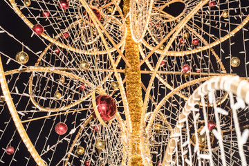 Christmas decorations on beautiful green Christmas tree with garland.